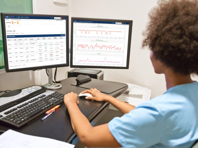 Young healthcare worker analyzing medical record on computer screen. Female nurse is working at desk. She is sitting in hospital.